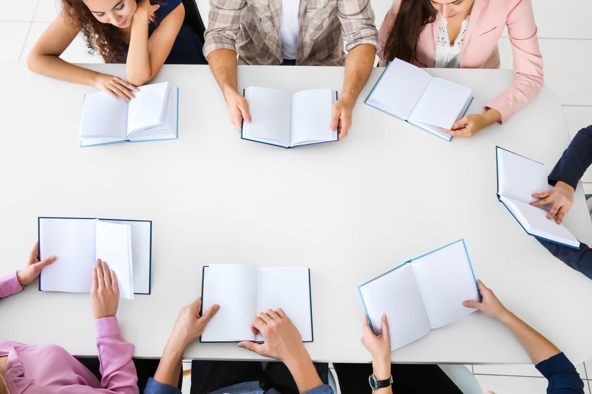 People Sitting at Table in Book Club